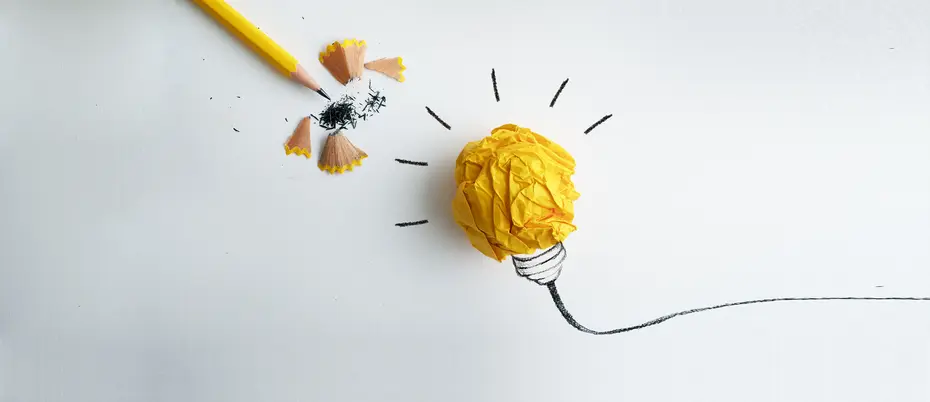 Crumbled yellow paper forming a lightbulb and pencil forming flower