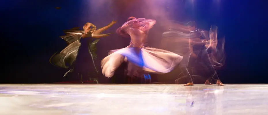 Three dancers in motion blur