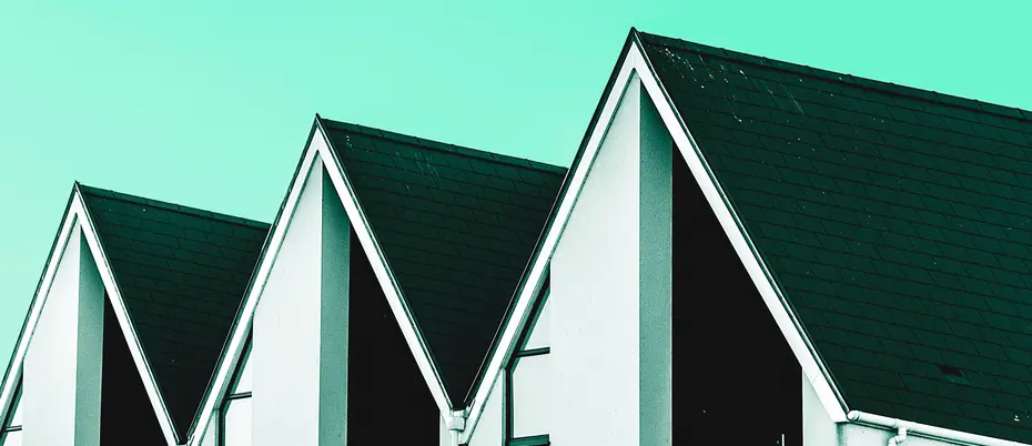 A row of houses with pointy roofs