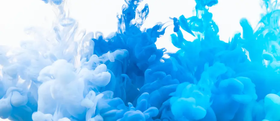 Blue ink droplets in water dispersing artistically