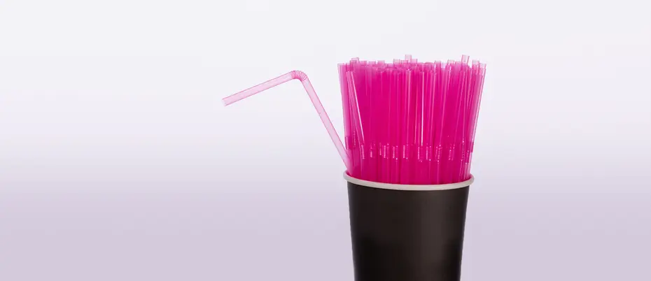 One bent straw in a cup of straight straws.