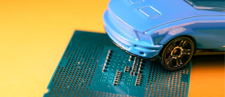 A toy car sits on top of a microchip