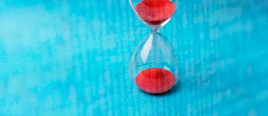 An hour glass juxtaposed with data and letters 