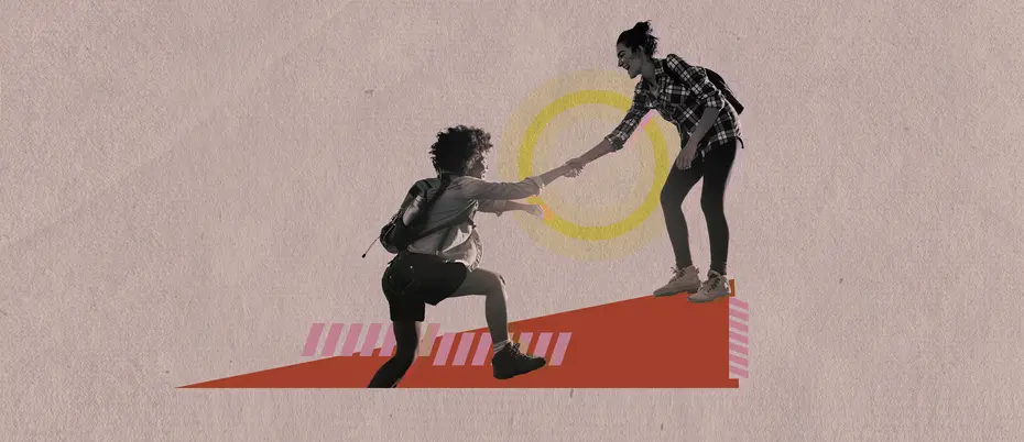 A woman helps another woman cross a barrier