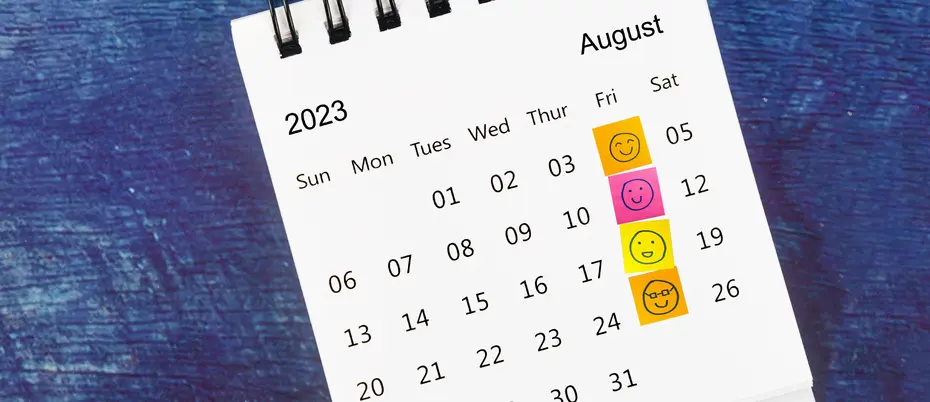 Happy face sticky notes cover the Friday column on a calendar