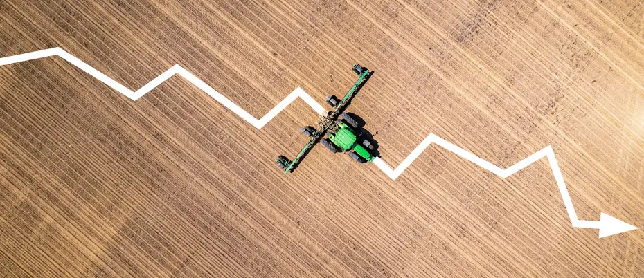 A downward sloped graph is overlayed on top of a John Deere tractor photograph
