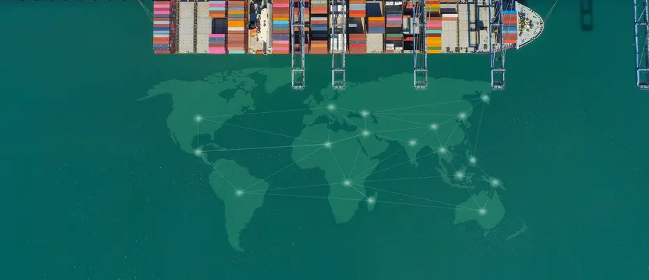 A cargo ship in the ocean. A world map is transposed in the water.