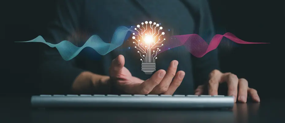 A business person in front of a computer holds a glowing light bulb made of AI network lines emitting sound waves