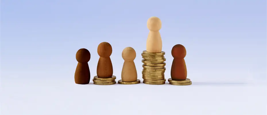 Different colored pawns on top of various stacks of coins