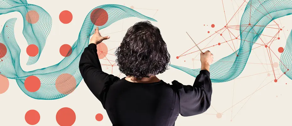 A maestro is in front of various technological graphics