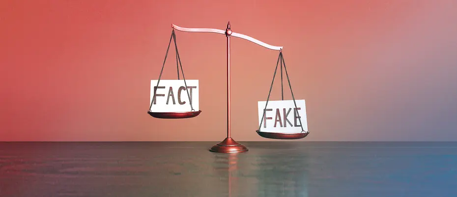 A justice scale has the word "Fact" on one side and "Fake" on the other.
