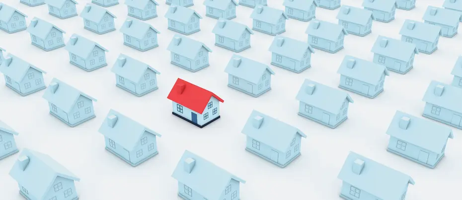 Rows of faint light blue houses with one red one standing out from the crowd