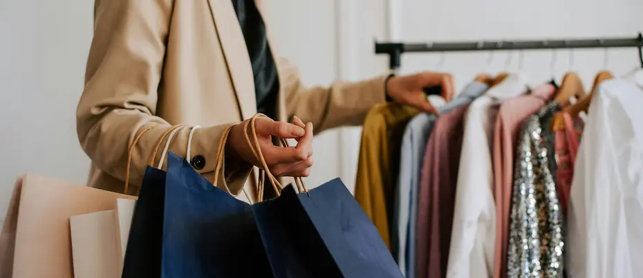 A customer peruses a rack of clothes