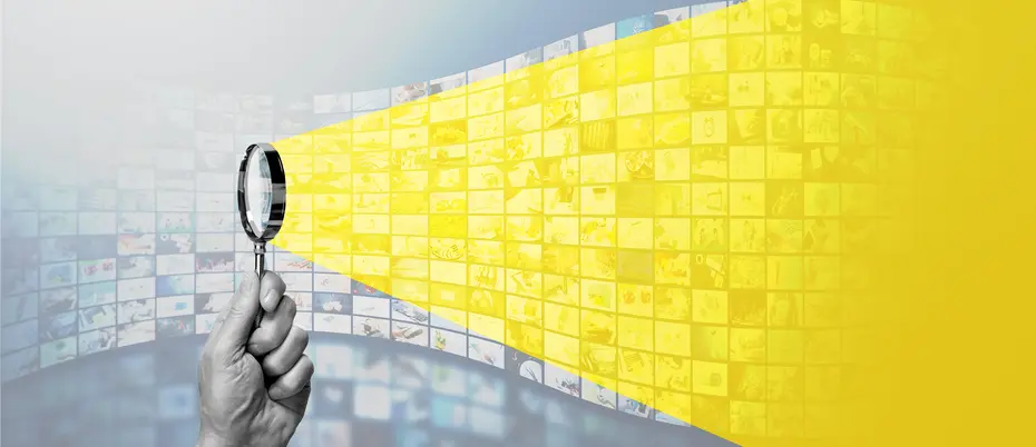 A magnifying glass shines a light on a wall of image collages