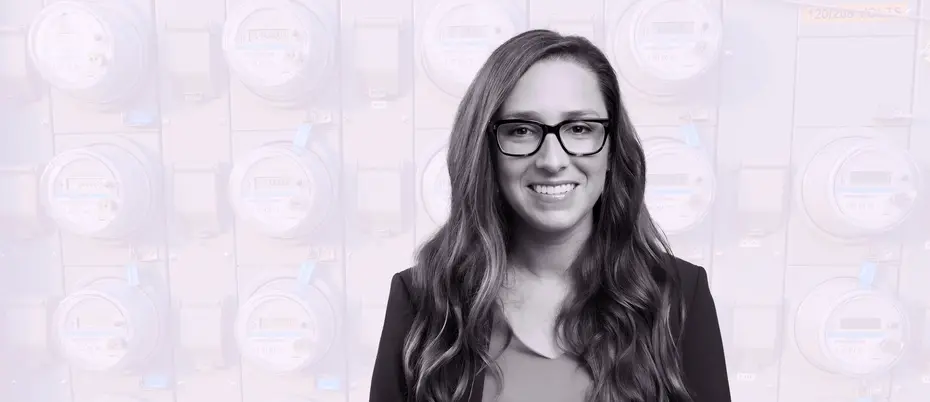 Jacqueline Pless amongst a background of digital electricity meters