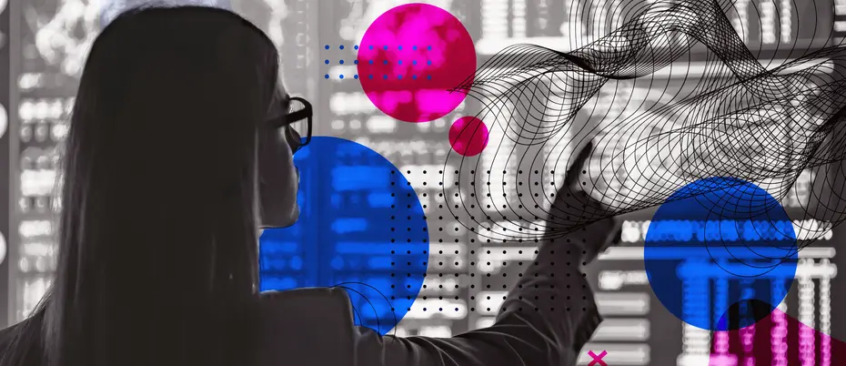 A worker points to a screen covered in code and geometric shapes