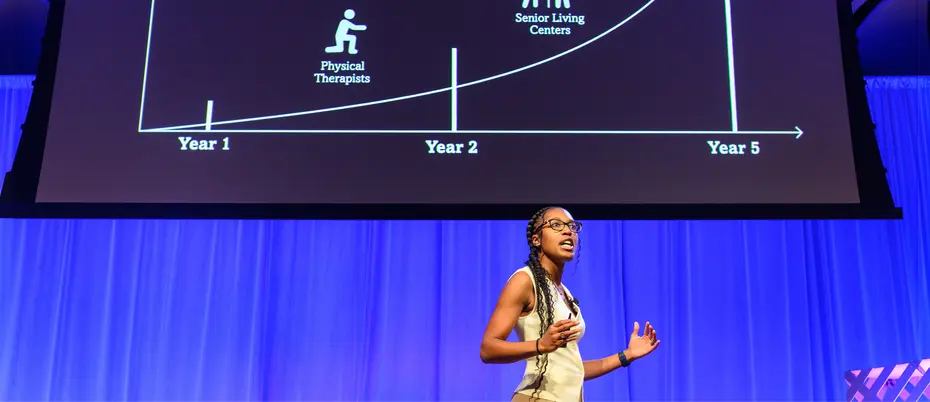 Qadence startup presents on stage at MIT Delta V Demo Day