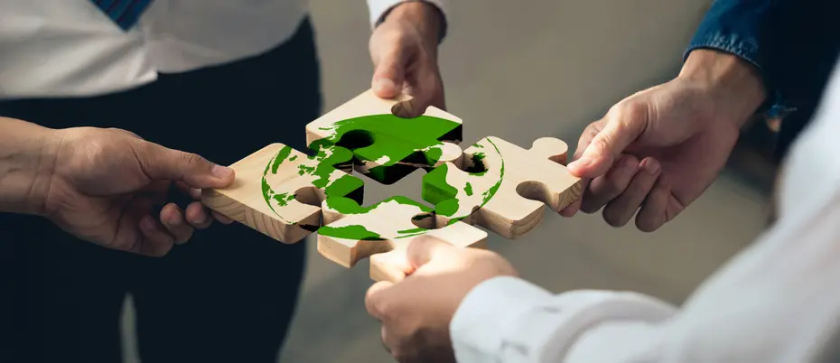 hands assembling climate jigsaw puzzle