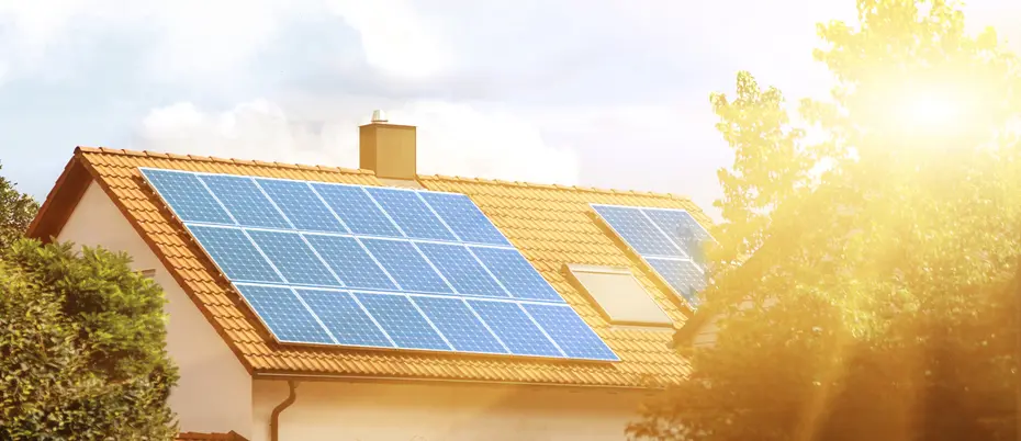 Solar panels on the tiled roof of the building in the sun. Electricity production for own needs and for sale