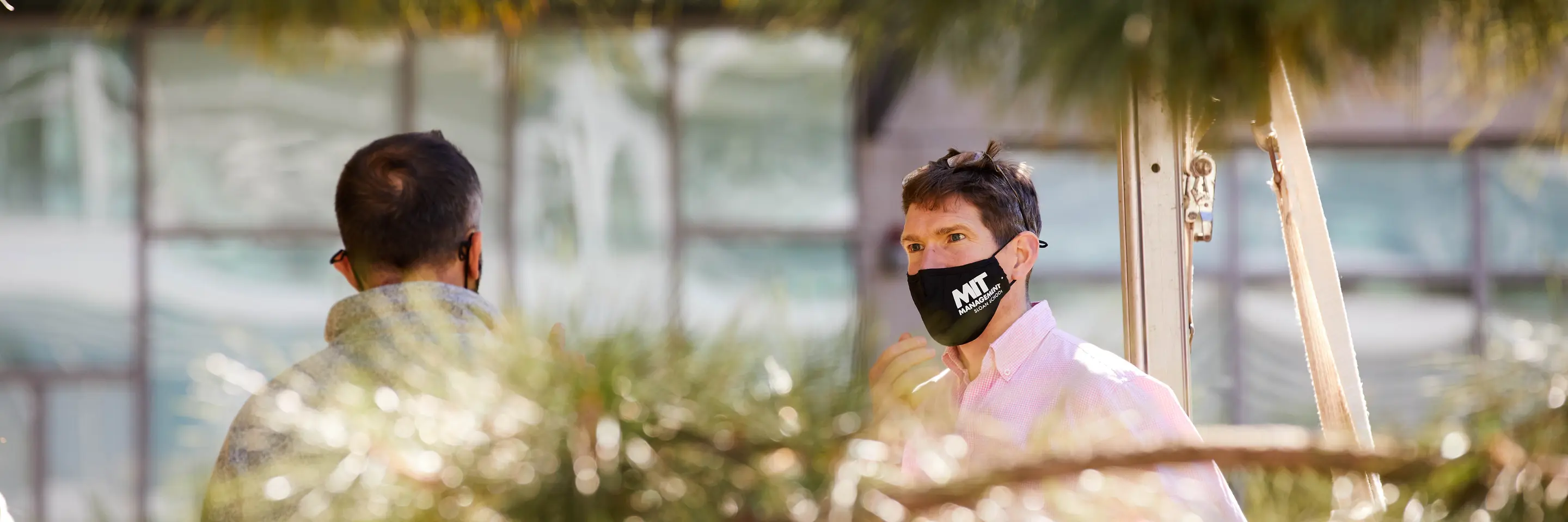 A photo of people talking on campus