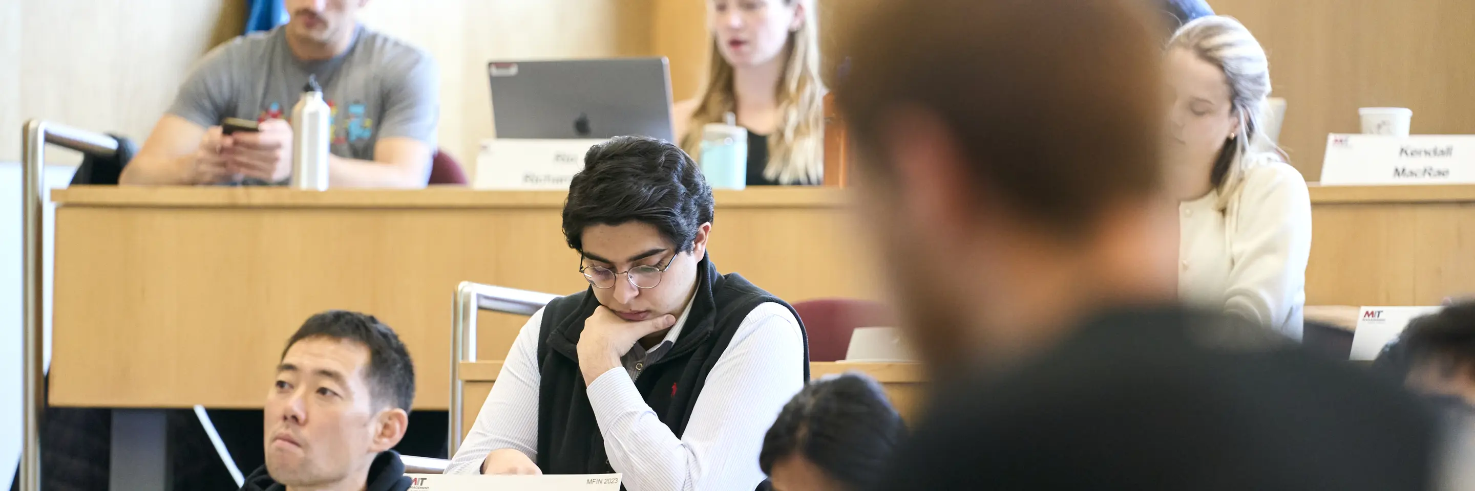 Sandro sitting in class, surrounded by other students