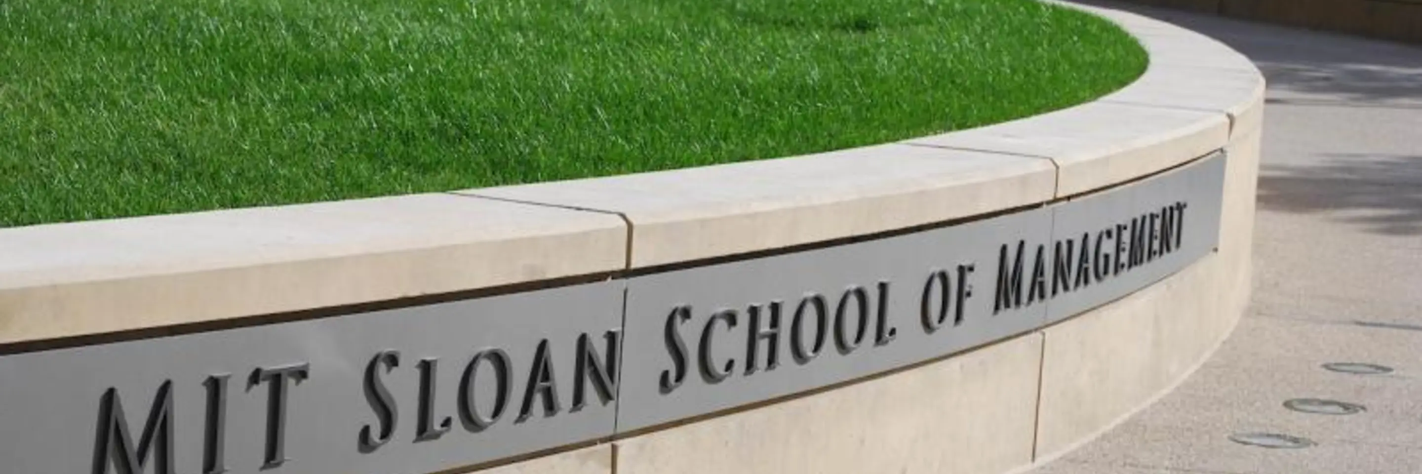 Image of the words MIT Sloan School of Management on a wall outside of 100 Main Street