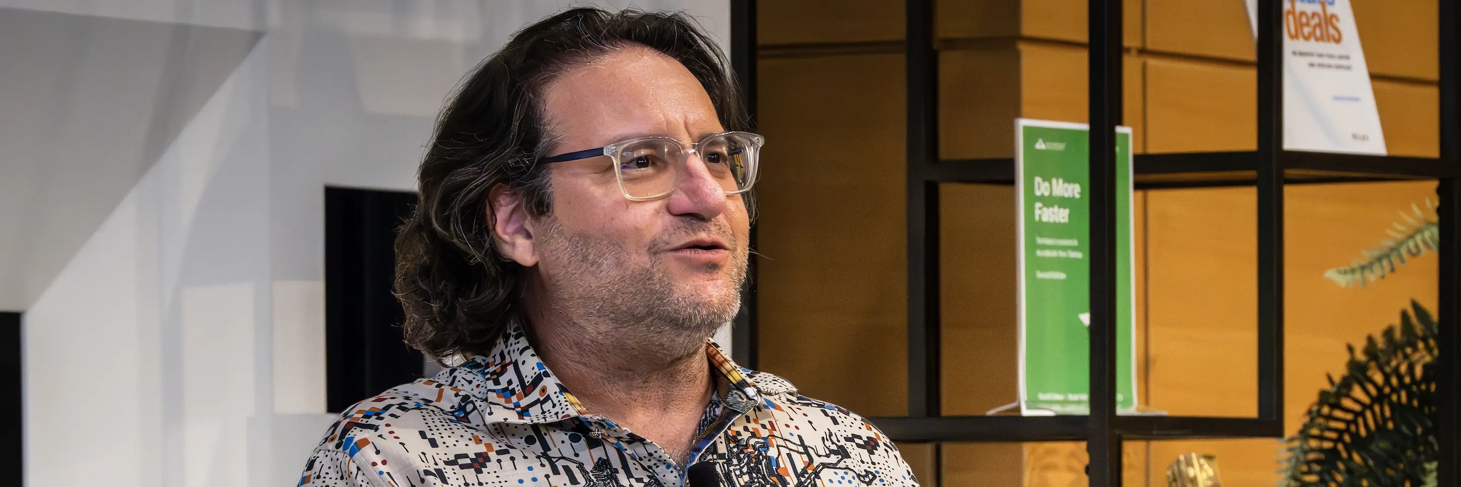Man with glasses and collared shirt.