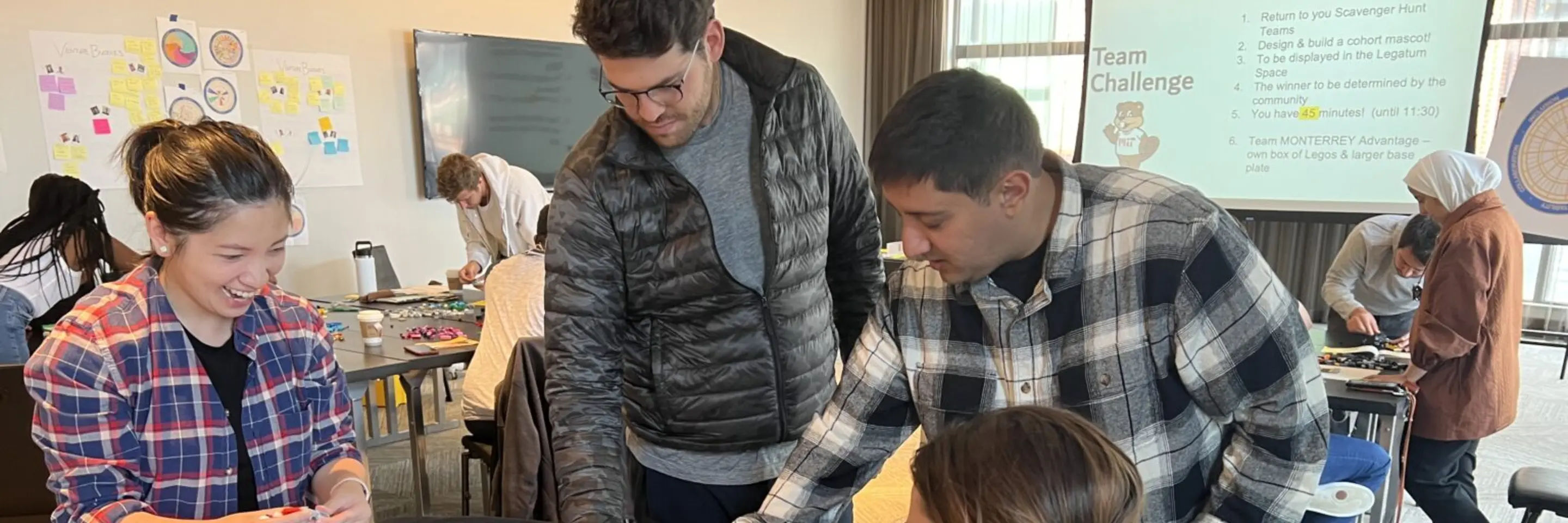 Group of entrepreneurs in classroom working on a project together at a table
