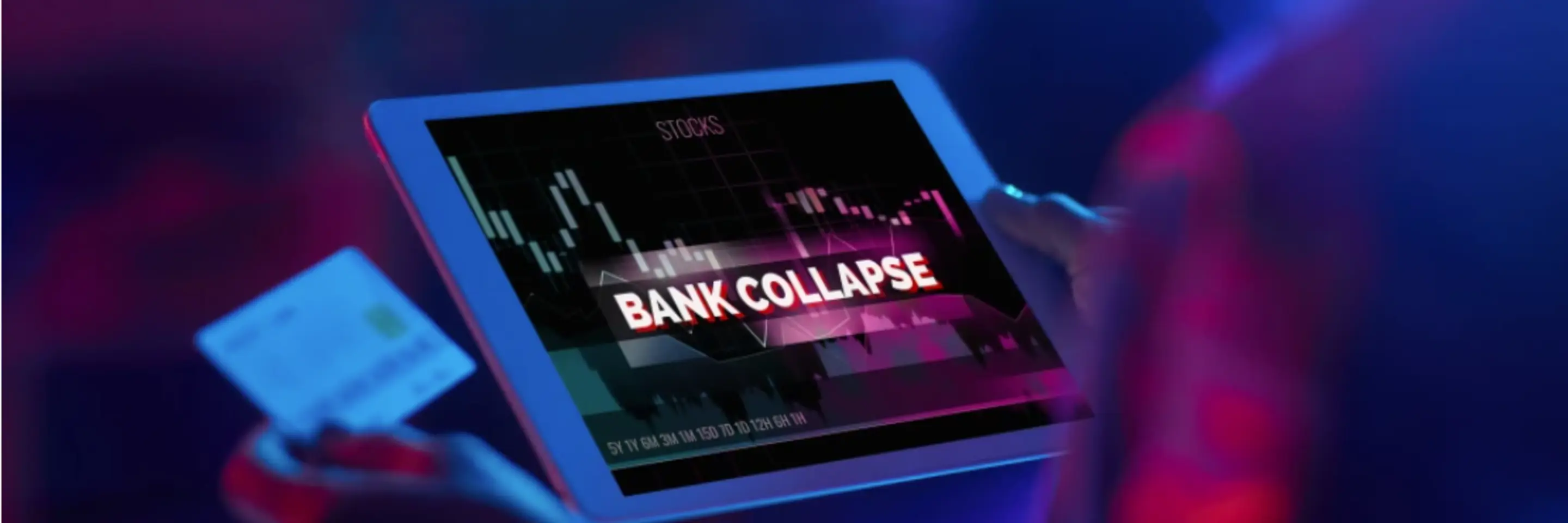 person holding a tablet with the words BANK COLLAPSE on screen