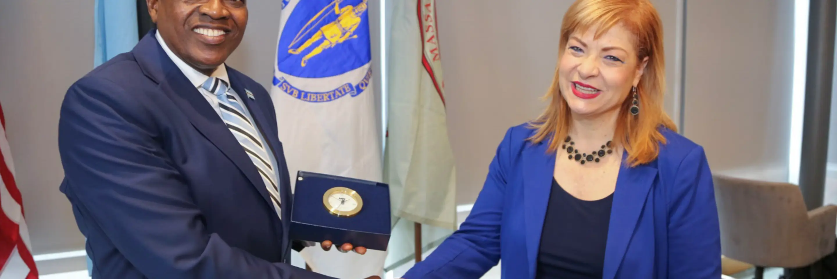 Photo of man and woman shaking hands and smiling to camera