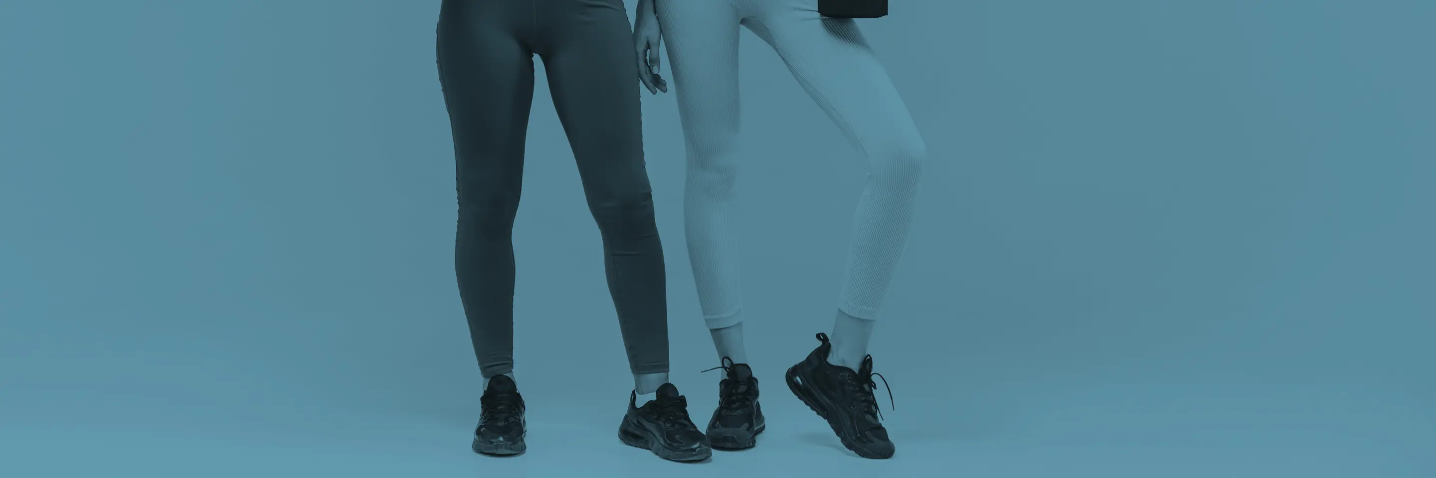 Colored image of two individuals wearing yoga pants