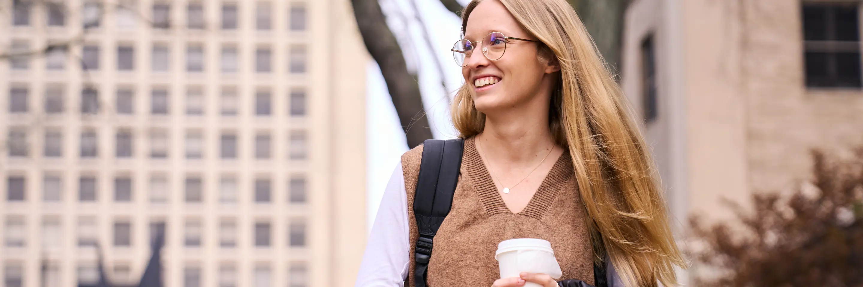 Anne Buisson walks outside on the MIT Sloan campus.