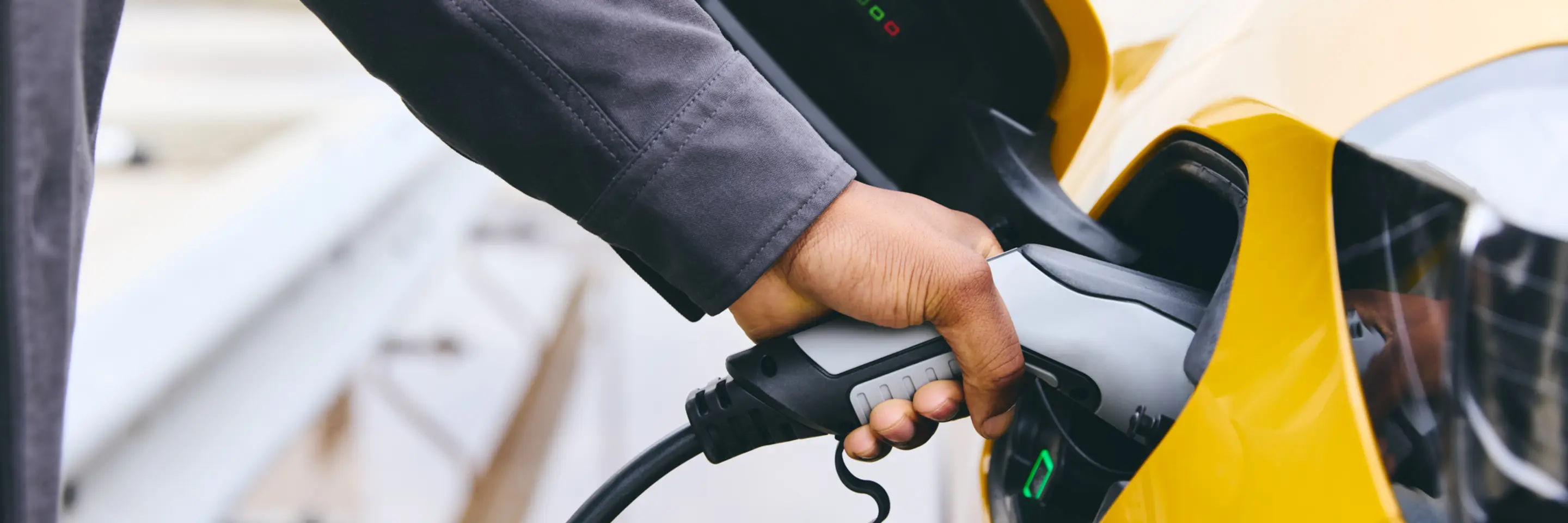 Hand plugging a charger in EV