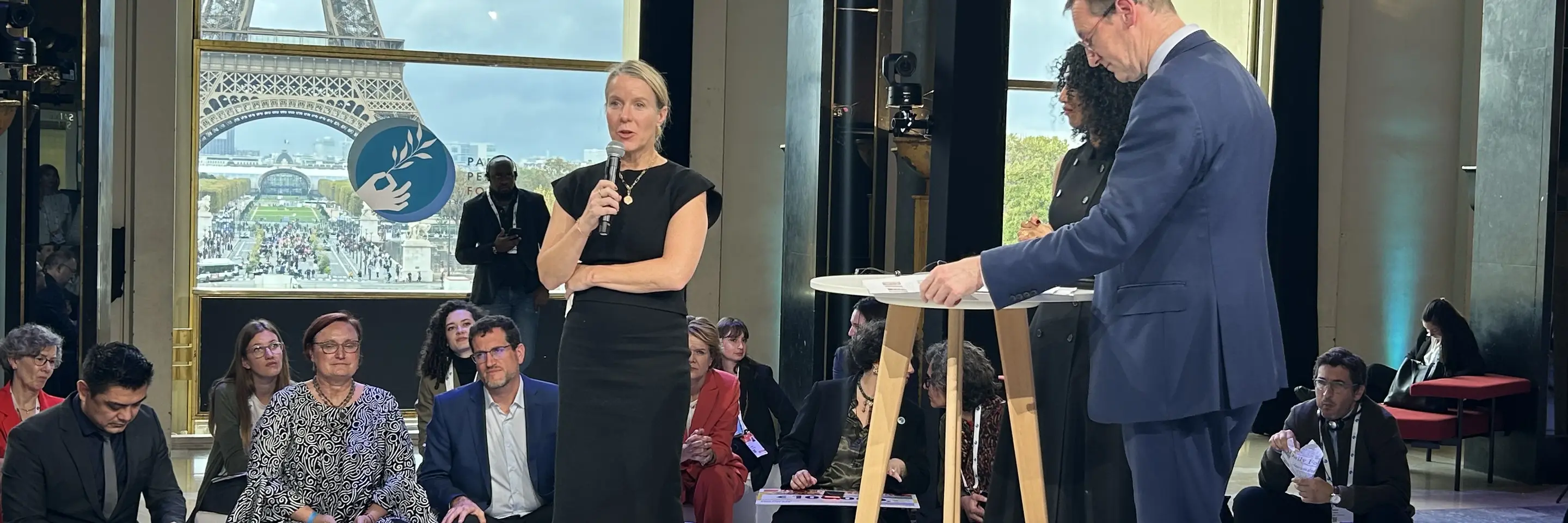 MIT Climate Policy Center Executive Director Bethany Patten Presents at the Paris Peace Forum. Eiffel Tower visible through window in background