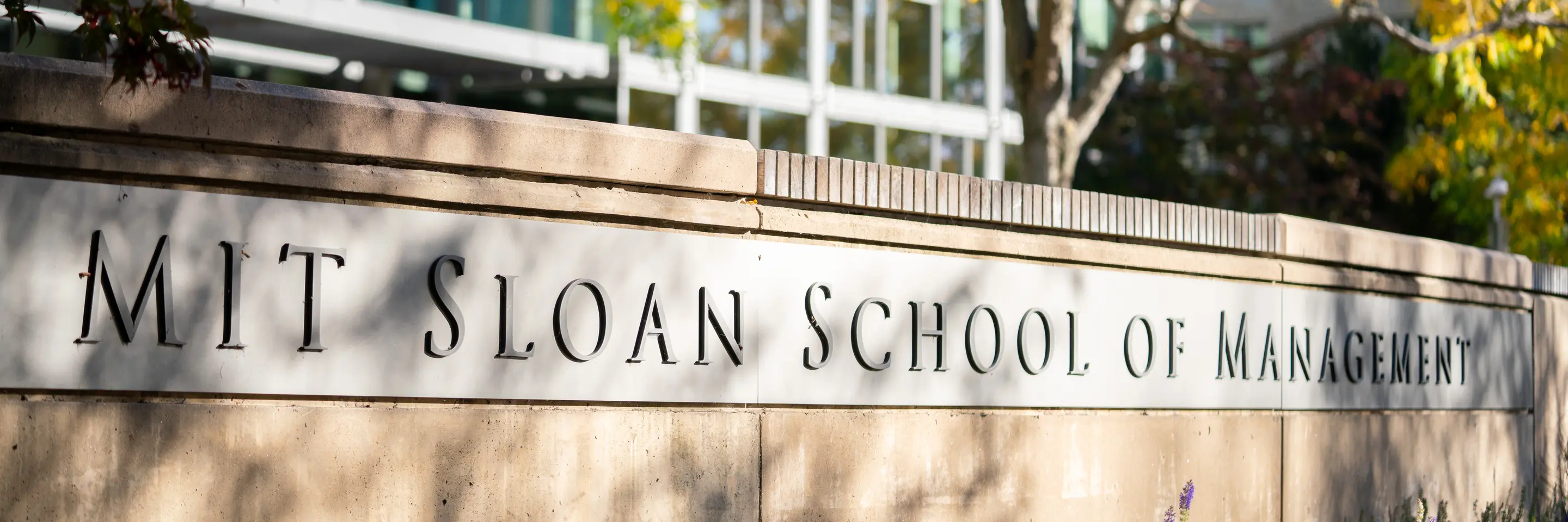 Inscription on wall outside of building E62 reading MIT Sloan School of Management
