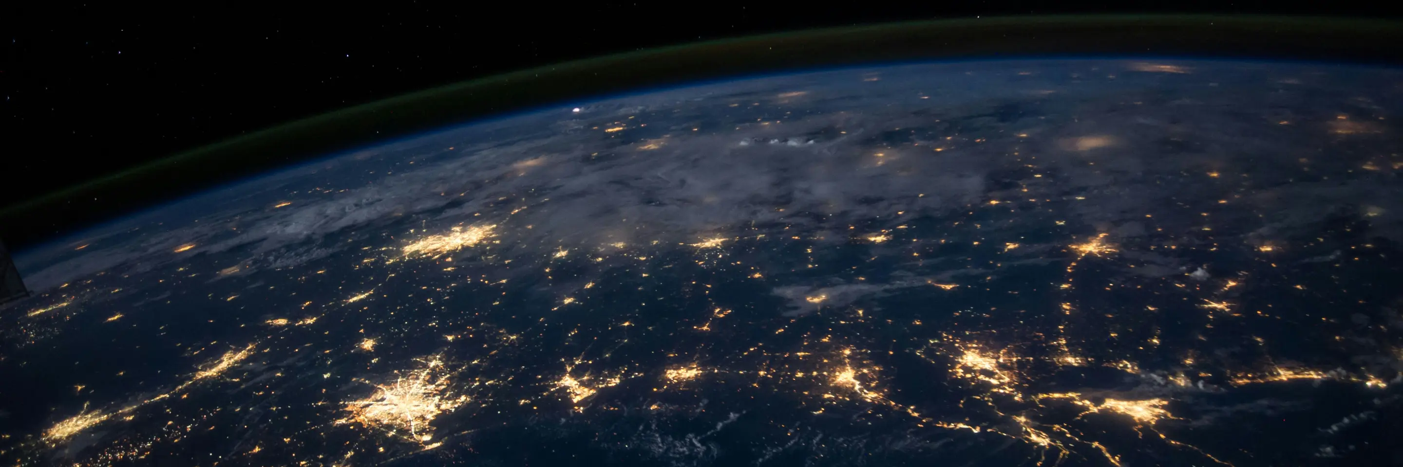 space level view of the earth, lights of major cities visible 