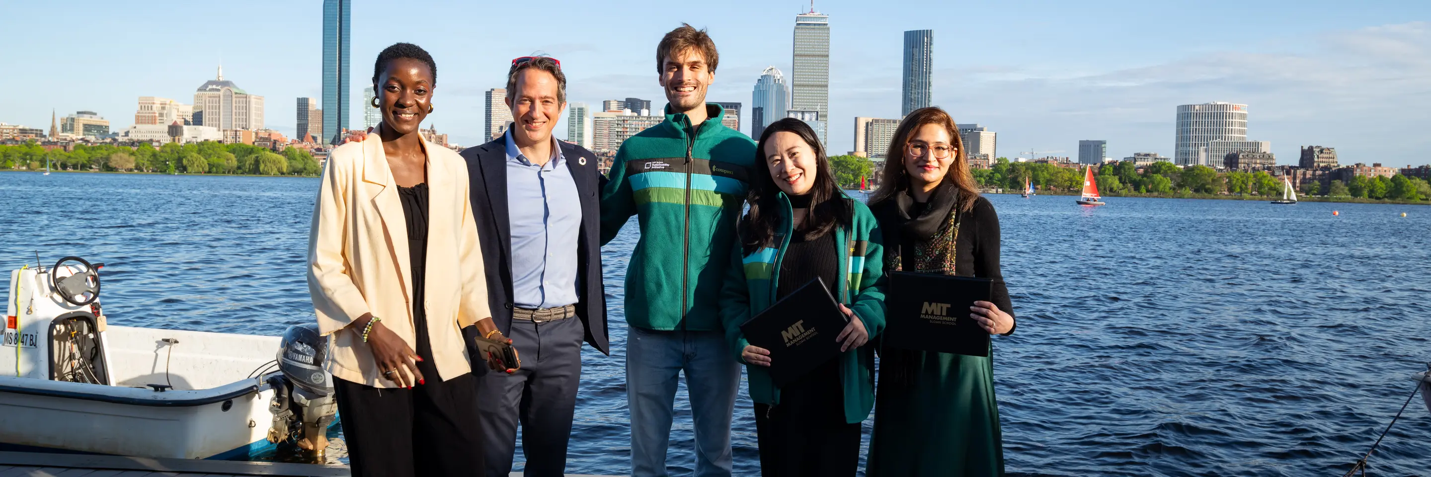 members of the SISC group in front of the river and boston skyline