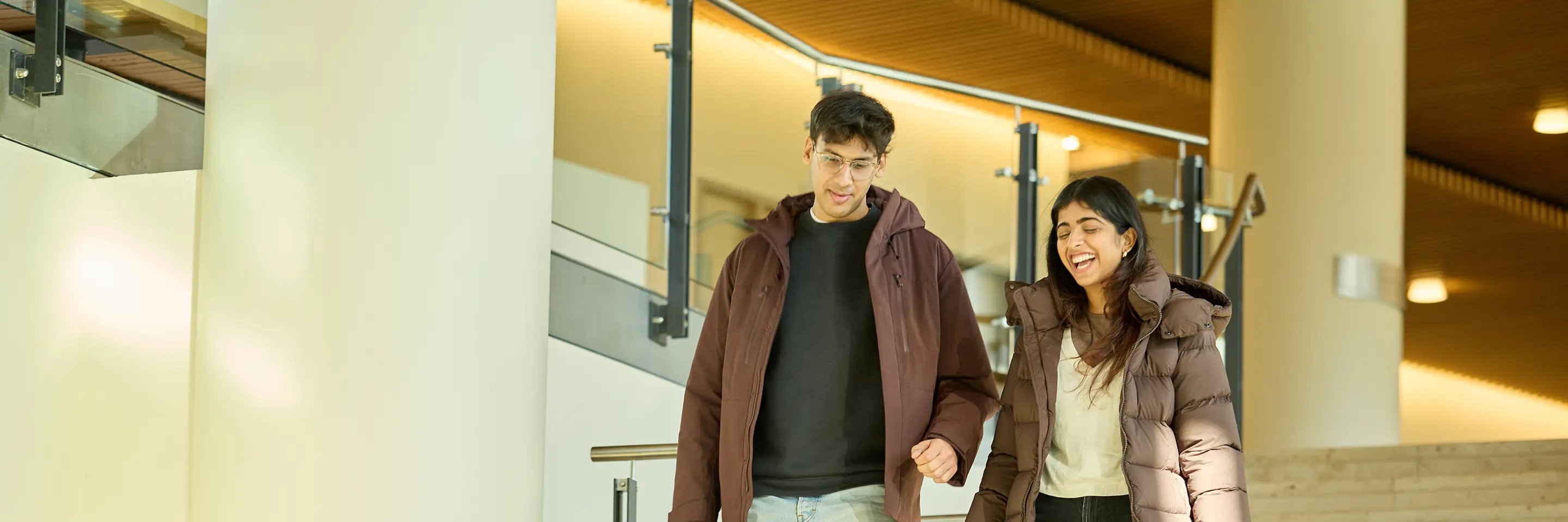 Two people talking while walking down stairs