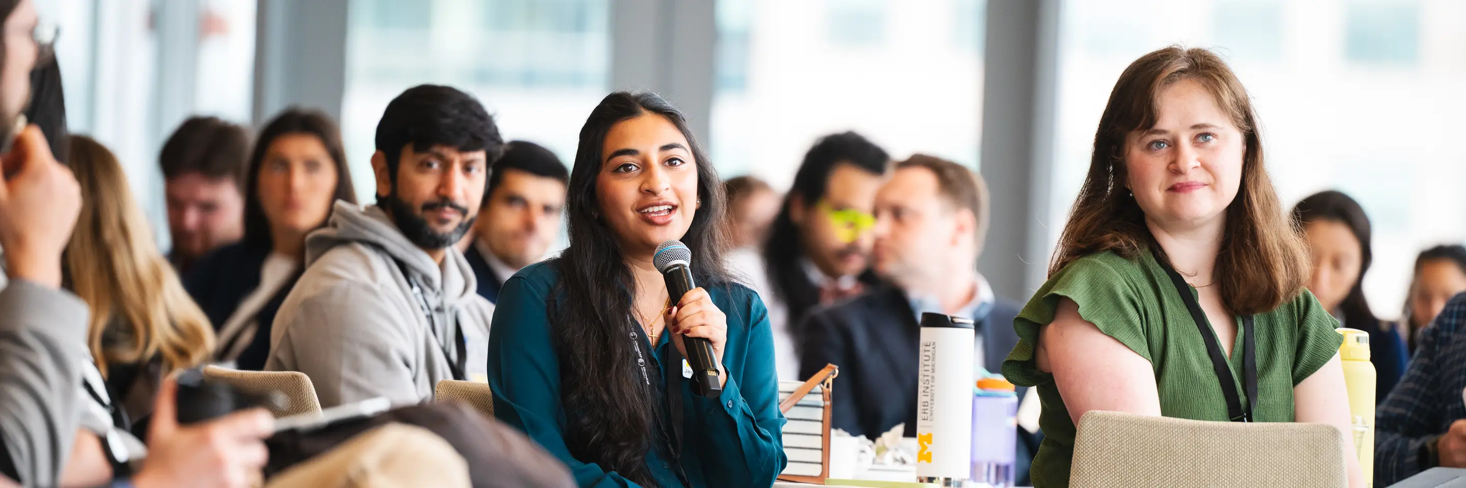ClimateCAP attendee holding microphone in audience