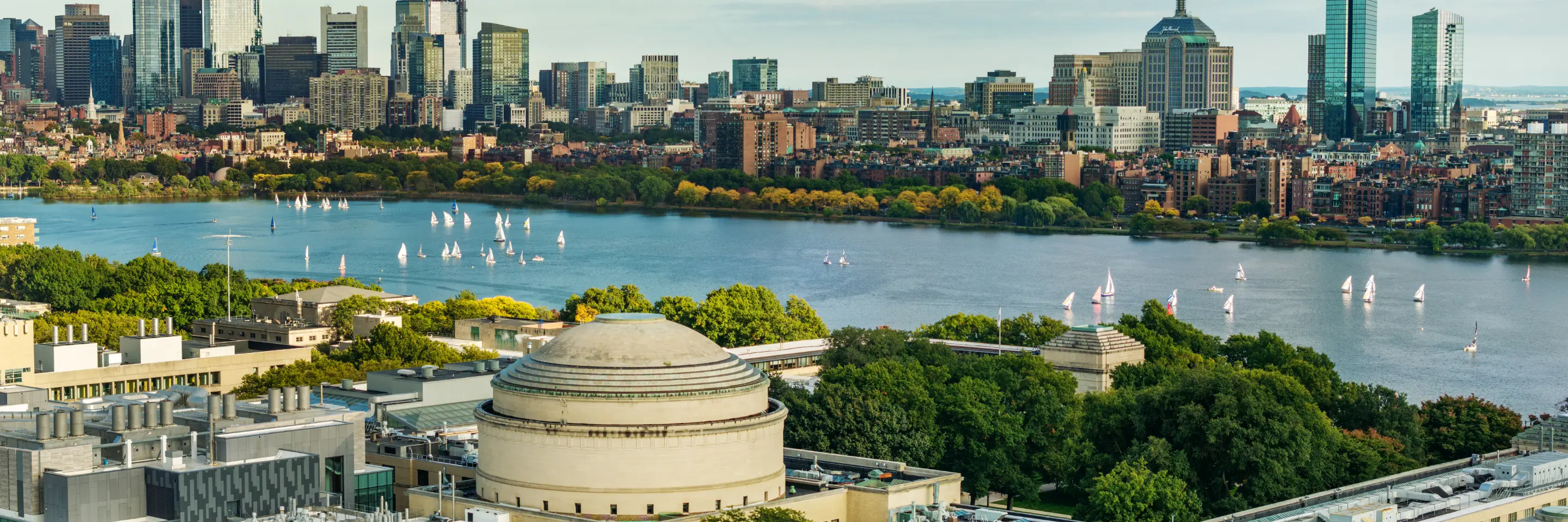 Aerial photo of Boston across the Charles River with the MIT Great Dome in the foreground