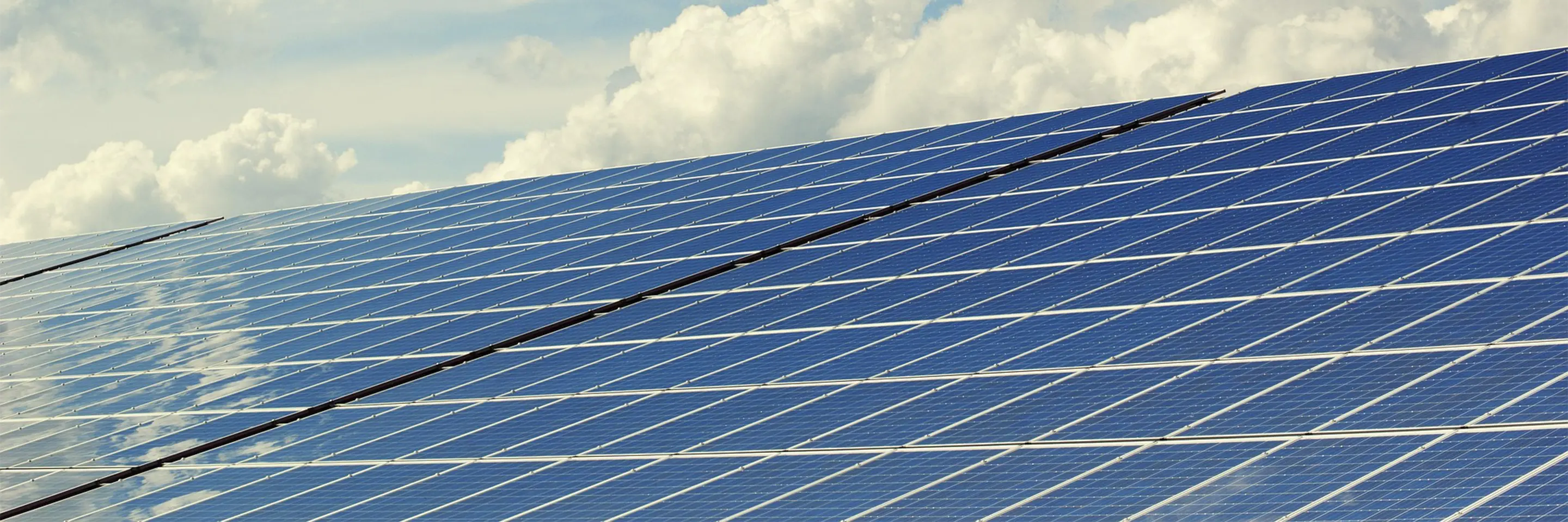 Image of Solar Panels with Clouds in the Background