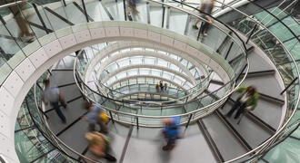 Photograph of a circular staircase and people quickly moving up and down