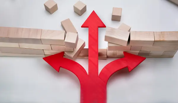 An arrow breaks through a wall of wooden blocks