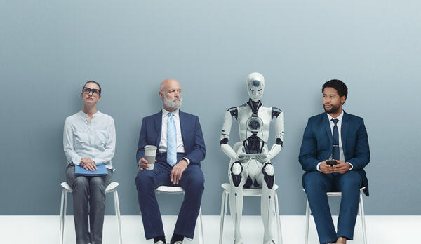 Three professionals and a robot sit in a waiting room