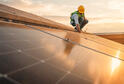 A person does work on a solar roof