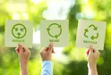 People holding recycling signs