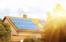 Solar panels on the tiled roof of the building in the sun. Electricity production for own needs and for sale