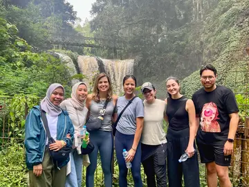 Photo of G-Lab team in front of a waterfall