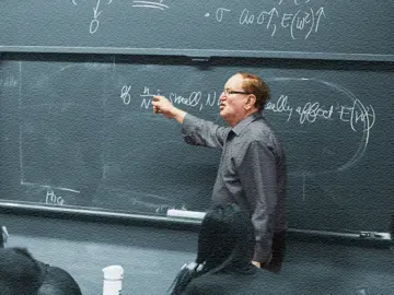 Arnold Barnett teaching at a chalkboard.