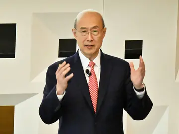 A person delivers a lecture to a crowded auditorium